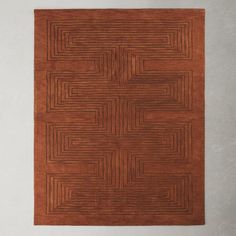 a brown area rug with an interlocked design on the top and bottom part