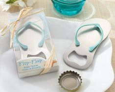 two flip flop bottle openers sitting on top of a white plate