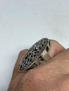 Vintage ring surrounded by Swiss cut fine Marcasite Sterling silver Size 6.25 can be sized by my jeweler. His service charge is $10-$20 All rings are shipped free in the US in a nice gift box. Check out our over a THOUSAND great reviews Engraving is $4 per letter and is not always perfect depending on the piece. It can take a few days if the jeweler is busy. This is payable to Paypal Judithsltd@gmail.com Art Deco Silver Filigree Ring As Gift, Silver Art Deco Filigree Ring As Gift, Silver Filigree Ring, Art Deco Style, Gift, Silver Art Deco Filigree Ring Gift, Marcasite Rings Stamped 925 As A Gift, Marcasite Sterling Silver Rings For Gifts, Stamped 925 Marcasite Rings For Gifts, Silver Art Deco Ring Gift, Gift Rings Stamped 925 With Marcasite