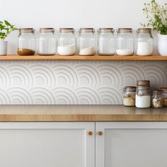 some jars are lined up on a shelf