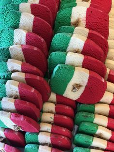 many different colored donuts stacked on top of each other in the shape of italy