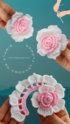 three crocheted flowers are being held in the air by two hands, one is pink and white