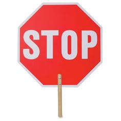 a red stop sign with a wooden stick sticking out of it's bottom corner