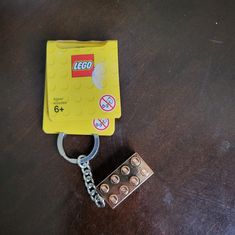 a lego keychain is sitting on top of a table