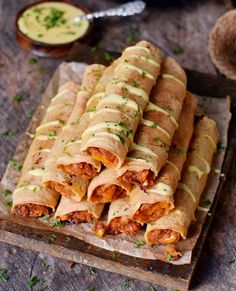 some food that is sitting on a wooden tray and ready to be eaten by someone