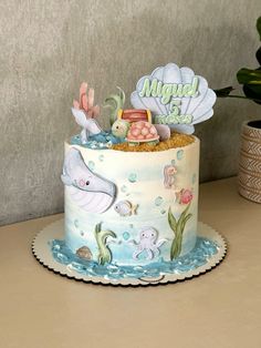 there is a birthday cake with an ocean theme on the top and under it's name