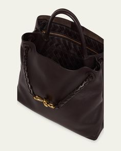 Bottega Veneta "Andiamo" tote bag in silky calf leather     Top handle     Sliding shoulder strap with knot hardware accent     Can be worn as a top handle or shoulder bag     Open top with magnetic closure     Interior, one zip pocket and two slip pockets     Lining: Suede    Feet protect bottom of bag     Approx. 9.8"H x 12.5"W x 4.3"D    Made in Italy Designer Shoulder Bag With Rolled Handles For Daily Use, Luxury Formal Shoulder Bag With Rolled Handles, Timeless Formal Bag With Rolled Handles, Luxury Shoulder Bag With Rolled Round Handles, Luxury Calf Leather Hobo Tote Bag, Designer Everyday Shoulder Bag With Rolled Handles, Designer Shoulder Bag With Rolled Handles For Everyday, Designer Satchel With Rolled Handles For Formal Occasions, Designer Satchel With Rolled Handles For Formal Events