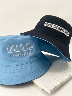 "Our Child of God bucket hats are reversible and beautifully embroidered. The baby blue side of this hat features \"Child of God\", but flip it inside out for a black bucket hat that features \"Praise The Most High\". Easily pair this hat with your wardrobe and enjoy for the upcoming spring and summer months! *choose from 2 sizes: regular (58 cm) and large (60 cm)" Blue Bucket Hat, Designer Bucket Hats, Christian Hats, Hats Summer, Summer Hats Beach, Black Bucket Hat, Types Of Hats, Reversible Bucket Hat, Black Bucket