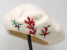 a white hat with red berries on it