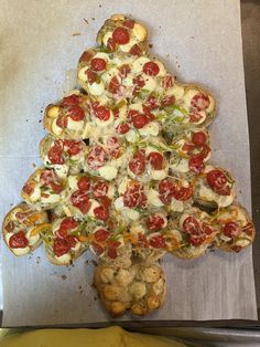 a christmas tree shaped pizza sitting on top of a pan