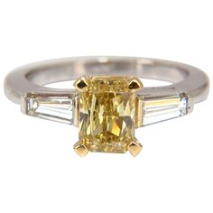 Radiant Yellow GIA Certified 1.37ct radiant cut diamond ring. Fancy Brownish yellow color Si-1 clarity Report Id: 2175348603 Please see attached photo for report. .75ct. Baguette, full cut diamonds. H Color Vs-2 clarity. 14kt white gold. 4 grams. current ring size: 6.25 We may resize, please inquire. $38000 Appraisal Certificate to accompany & GIA Certificate Radiant Cut Diamond Ring With Baguette Diamonds, Yellow Diamond Ring With Emerald Cut, Yellow Emerald-cut Diamond Ring, Yellow Emerald Cut Diamond Ring, Yellow Diamond Emerald Cut Ring, Yellow Diamond Ring With Emerald Cut Center Stone, Radiant Cut Diamond Ring With Single Cut Diamonds, Gia Certified Rectangular Yellow Gold Diamond Ring, Gia Certified Radiant Cut Yellow Diamond Ring