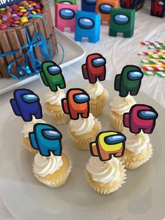 cupcakes with colorful decorations on a white plate