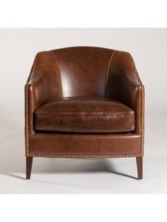 a brown leather chair with studding on the arms and back, in front of a white background