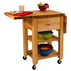 a kitchen island with two bowls on it and a cutting board attached to the top