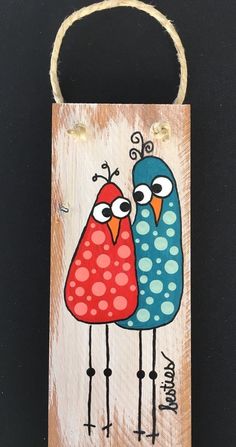 two birds are standing next to each other on a wooden sign that says happy birthday