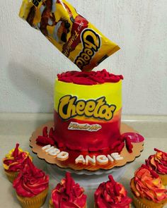 a birthday cake with candy on top and cupcakes in the bottom that say cheetos