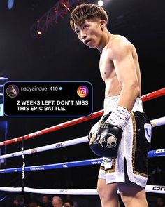 a young man standing next to a boxing ring