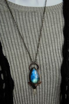 This necklace has been made with a stunning blue/green labradorite stone with a clear quartz crystal point and a black agate accent stone with a two leaf accent design. It is set with electroformed copper and has been oxidized for an antique finish. The pendant measures just under 3 inches long. It will come on a 24 inch chain in your choice of gunmetal(shown in photo) or dark copper. Just let me know if you would like your chain length customized at no extra cost. All metals used in my items ar Electroformed Teardrop Pendant Jewelry Gift, Adjustable Electroformed Bronze Necklace, Mystical Blue Labradorite Jewelry, Blue Electroformed Metal Jewelry, Silver Electroformed Crystal Necklace, Black Labradorite Pendant Necklace, Bohemian Copper Electroformed Necklace, Agate Stone Necklace, Black Agate Stone