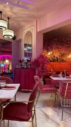 the interior of a restaurant with pink chairs and tables set up for an event or party