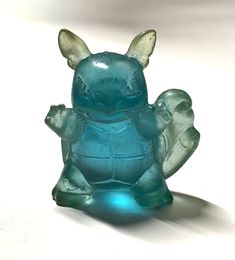 a blue glass figurine sitting on top of a table