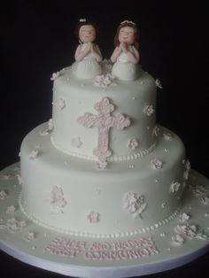 a wedding cake with two bride and groom figurines on top