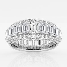 a white gold ring with baguetts and diamonds on the sides, set in 18k white gold