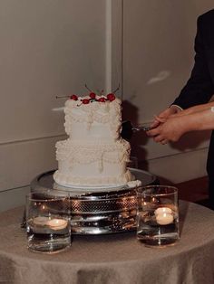 a bride and groom cutting their wedding cake