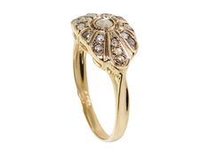 a gold ring with an oval shaped diamond in the center and two smaller round diamonds on each side