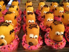 the simpsons donuts are decorated with pink frosting and chocolate sprinkles