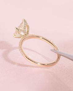 a close up of a ring with a diamond on it and a pair of scissors