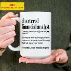 a person holding a coffee mug with the words chartered financial analist on it in front of them