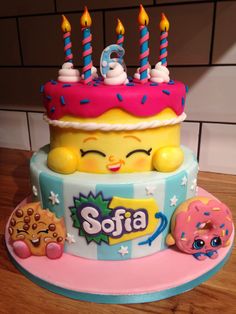 a birthday cake decorated with donuts and candles