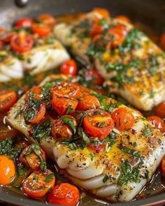 fish with tomatoes and herbs in a pan