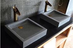 two sinks are shown on a black counter top