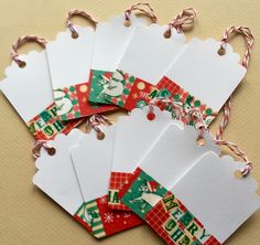 six christmas gift tags tied together with twine