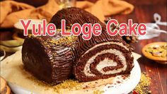 a close up of a cake on a plate with the words yule log cake