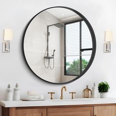 a bathroom with a round mirror above the sink