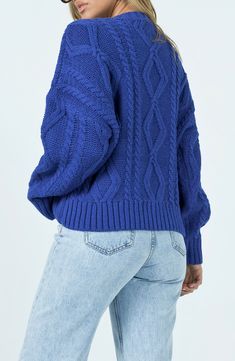 Chunky cable stitches keep you cozy in an oversized crewneck sweater that's trimmed with soft ribbing and perfect for the chillier seasons. Crewneck Long sleeves Ribbed cuffs and hem 100% polyester Hand wash, dry flat Imported