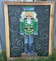 a painting of a nutcracker is on display in front of a wooden fence