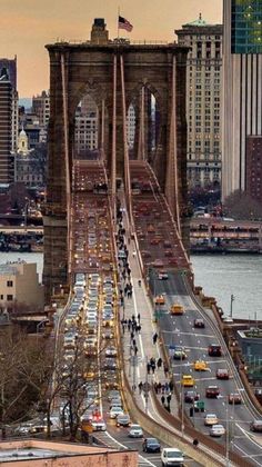 an aerial view of the brooklyn bridge in new york city, with traffic on it