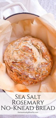 a loaf of sea salt rosemary no - knead bread in a round white bowl