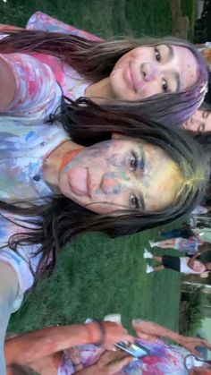 two girls with their faces covered in paint