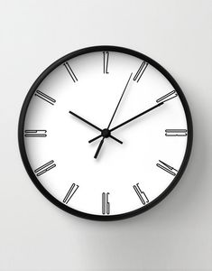 a black and white clock on the wall