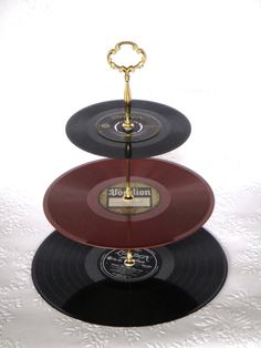 three records stacked on top of each other with a golden key hanging from the middle