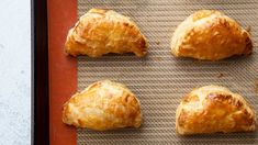 four pastries on a baking sheet ready to be baked