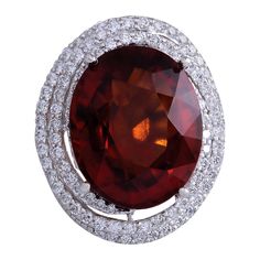 Indulge in the exquisite beauty of our Natural Hessonite Garnet Diamond Ring, meticulously crafted in opulent 14 Karat White Gold. Each element of this stunning piece speaks to impeccable craftsmanship and timeless elegance, making it a captivating addition to any jewelry collection. Adorning this ring is a breathtaking Hessonite Garnet gemstone, boasting a substantial weight of 18.50 carats and measuring 18.00x13.00 mm. Its warm, earthy tones radiate an unparalleled allure, while the surroundin Hessonite Ring, Clear Sunglasses Frames, Morganite Diamond Ring, 14k White Gold Diamond Ring, Garnet And Diamond Ring, Morganite Diamond, Hessonite Garnet, White Gold Set, Gold Cocktail Ring