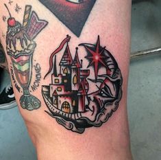 a tattoo on the leg of a woman with an image of a castle and a star