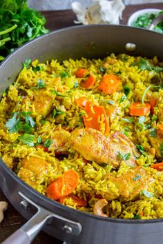 a pan filled with rice and vegetables on top of a table