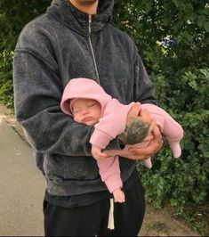 a man holding a baby in his arms