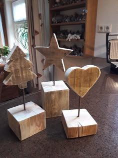 three wooden stars and two hearts on top of blocks in the middle of a kitchen